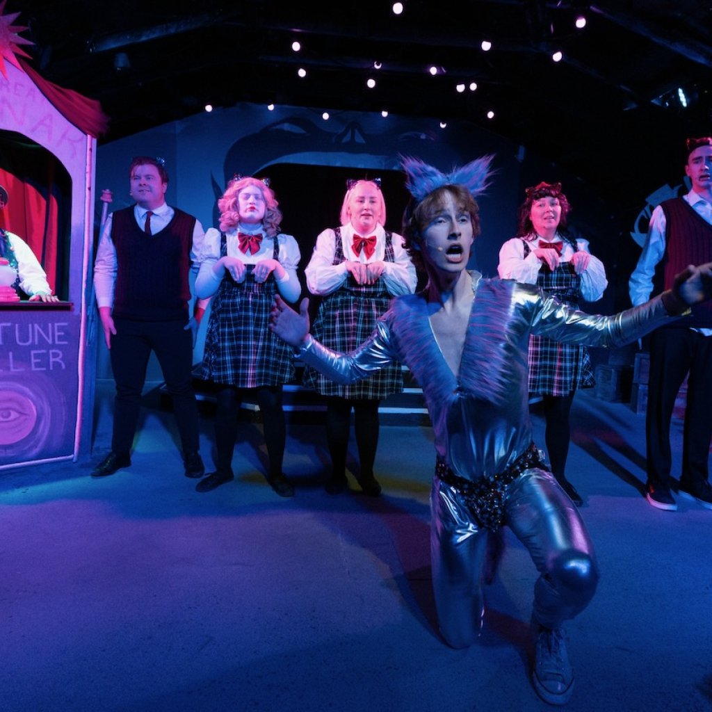 Archive photo of Ride the Cyclone. A young man in a space cat costume sings in front of the rest of the cast.