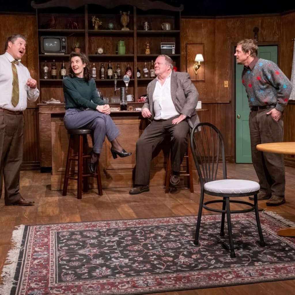 Four people in discussion in an Irish pub