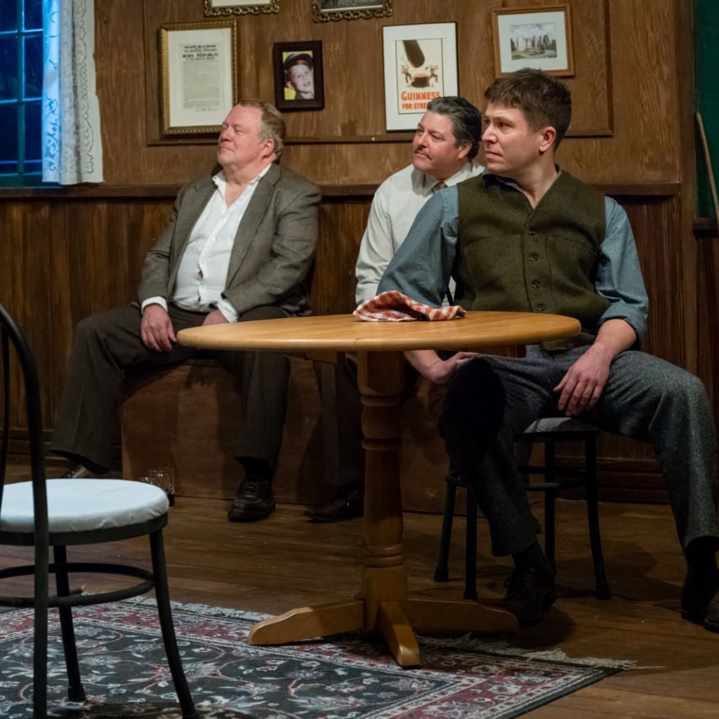 Three men seated in an Irish pub